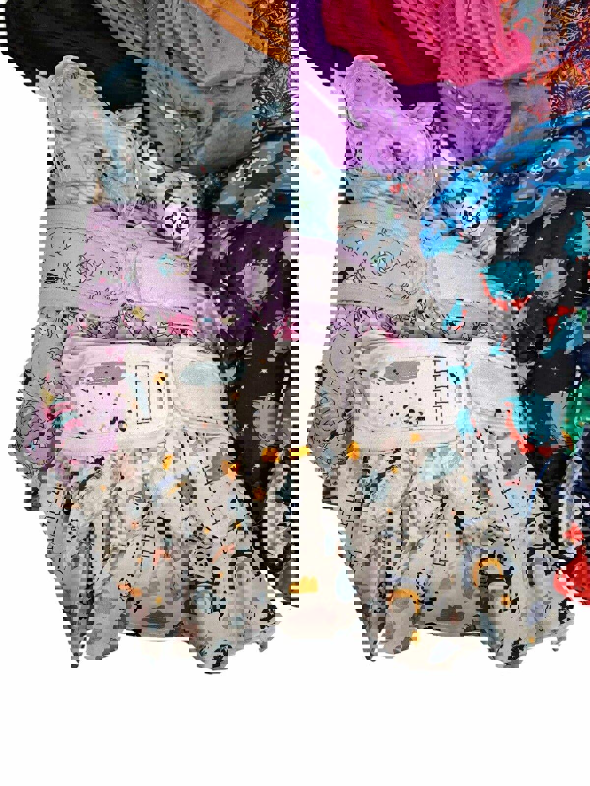 Colorful baby diapers featuring playful animal and cloud designs.