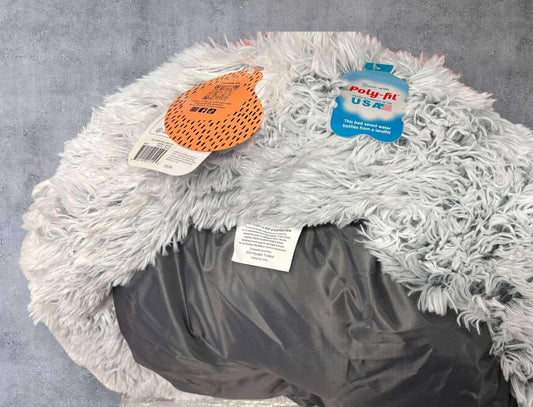 Cozy Pet Bed with fluffy gray exterior and waterproof bottom for comfort and durability.