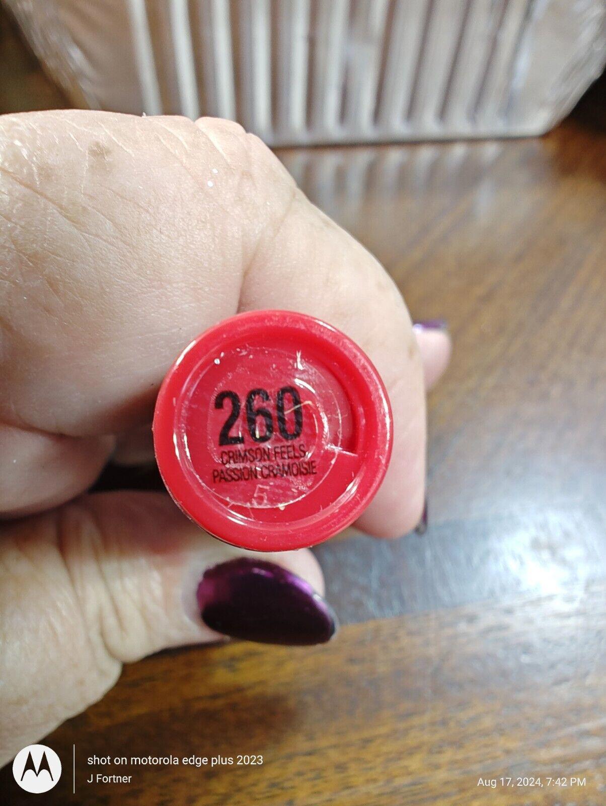 260 lipstick shade with a vibrant red color and glossy finish.
