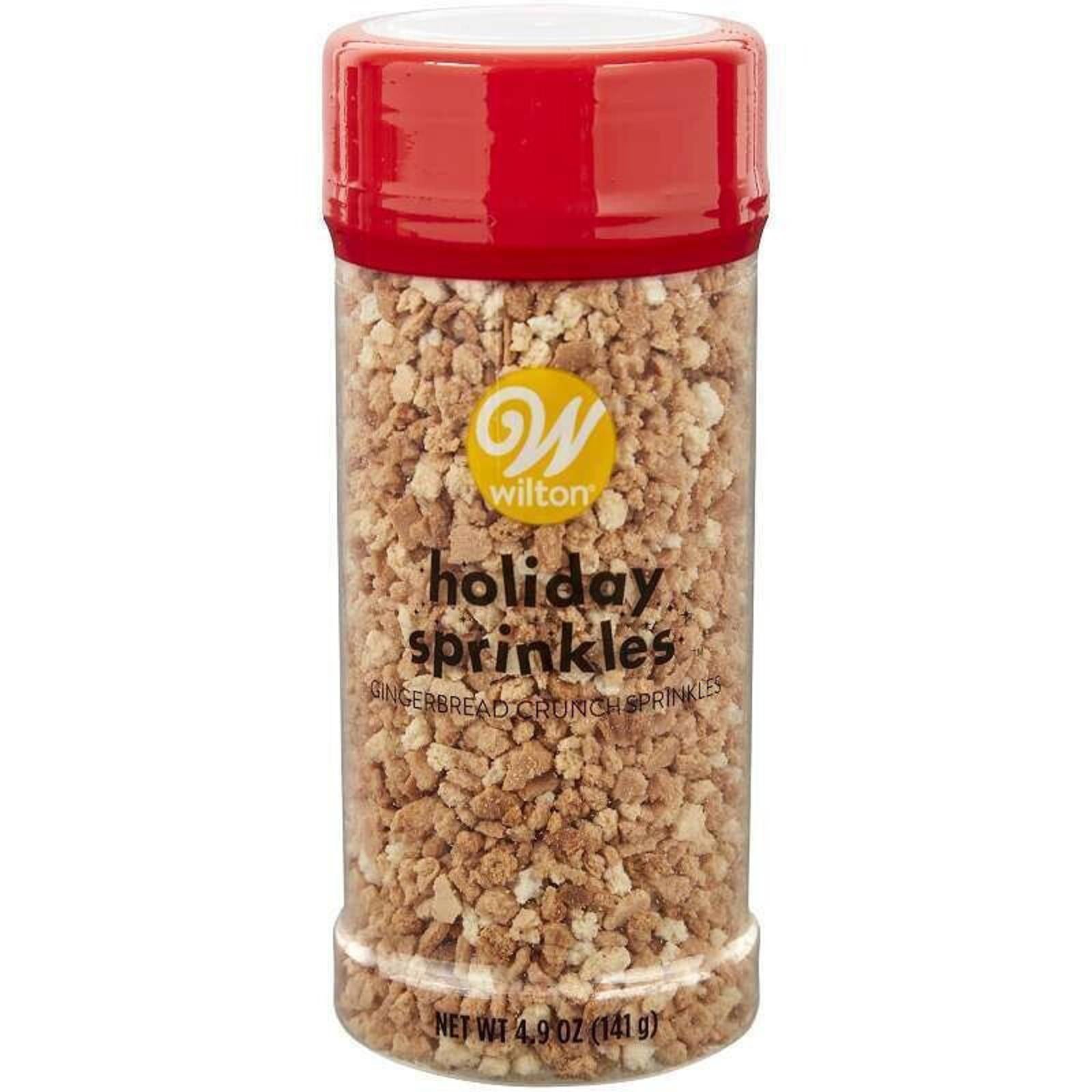 Wilton holiday sprinkles in a clear container with a red lid, perfect for festive baking.