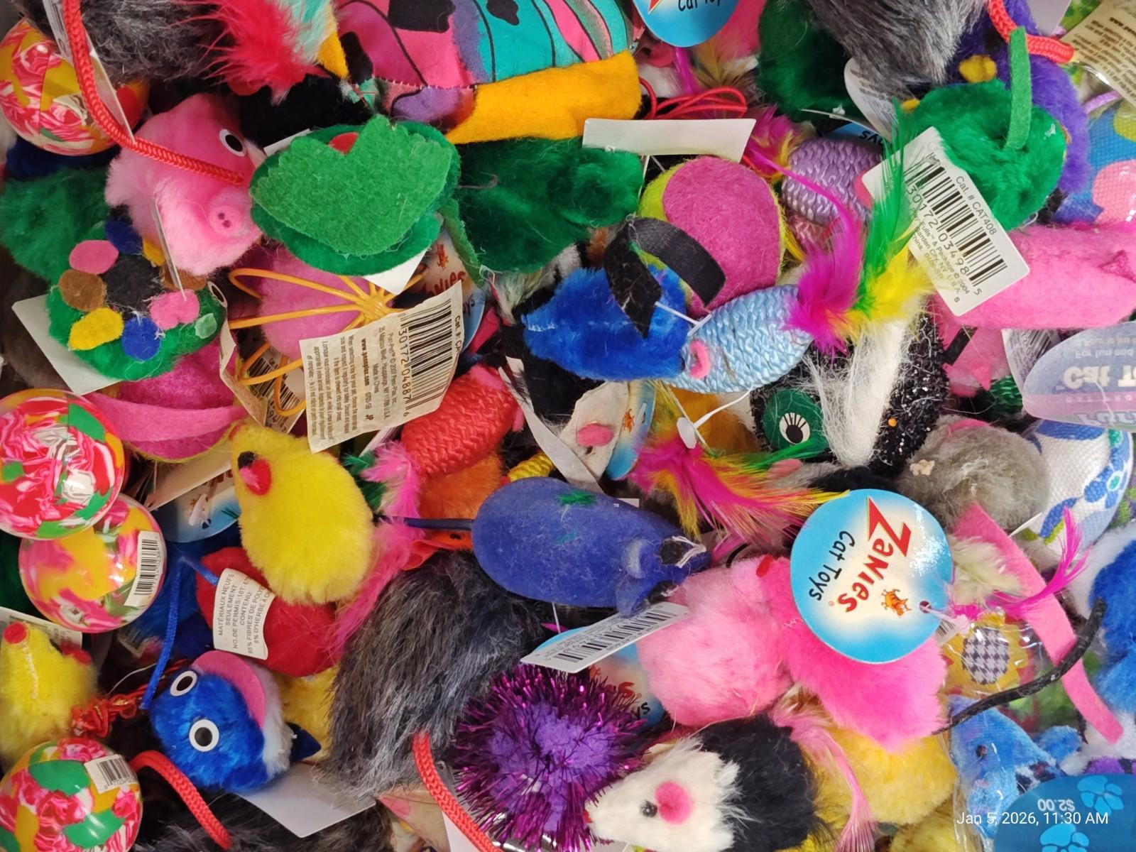 Colorful cat toys including various shapes and textures for playful pets.