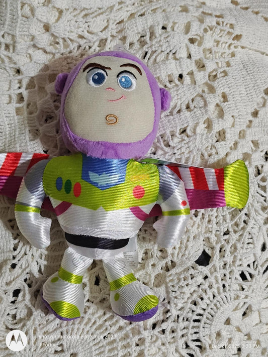 Buzz Lightyear plush toy with colorful wings and detailed facial features.