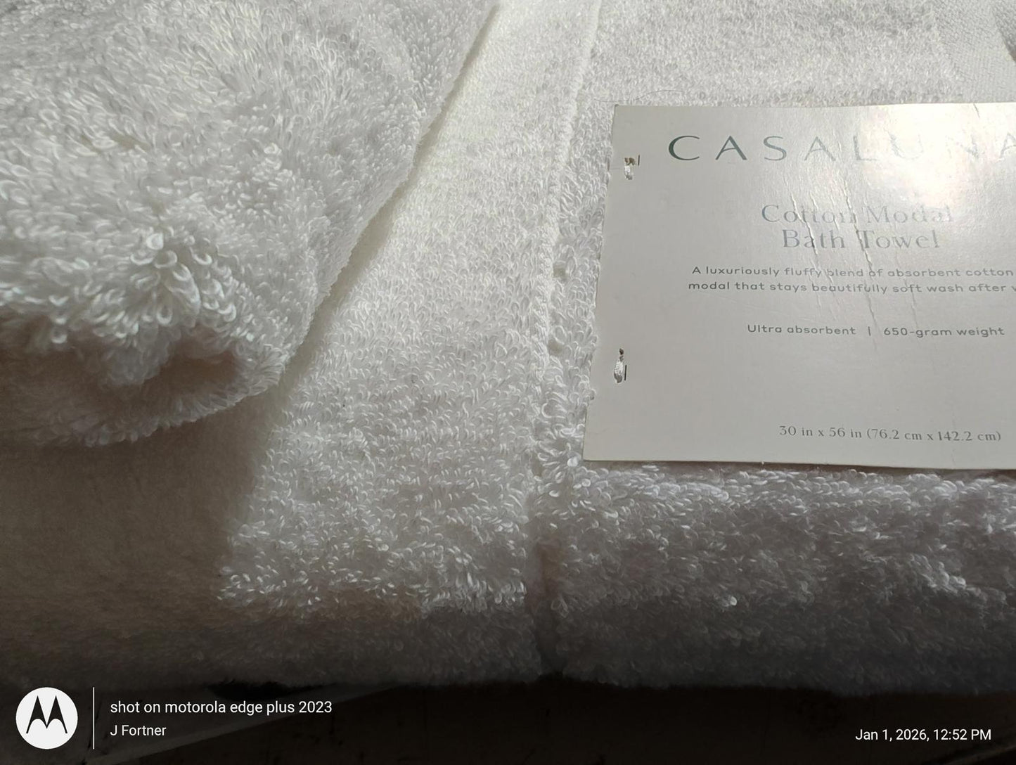 Casablanca cotton bath towel set featuring plush white fabric and elegant tag.