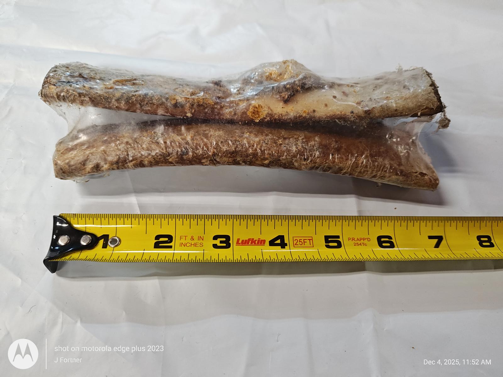 Dog Chew Bones, two natural treats packaged together with a measuring tape for size reference.