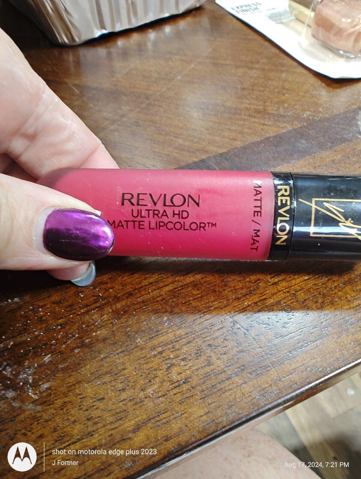 Revlon Ultra HD Matte Lipcolor in a vibrant pink shade held by a hand with purple nails.