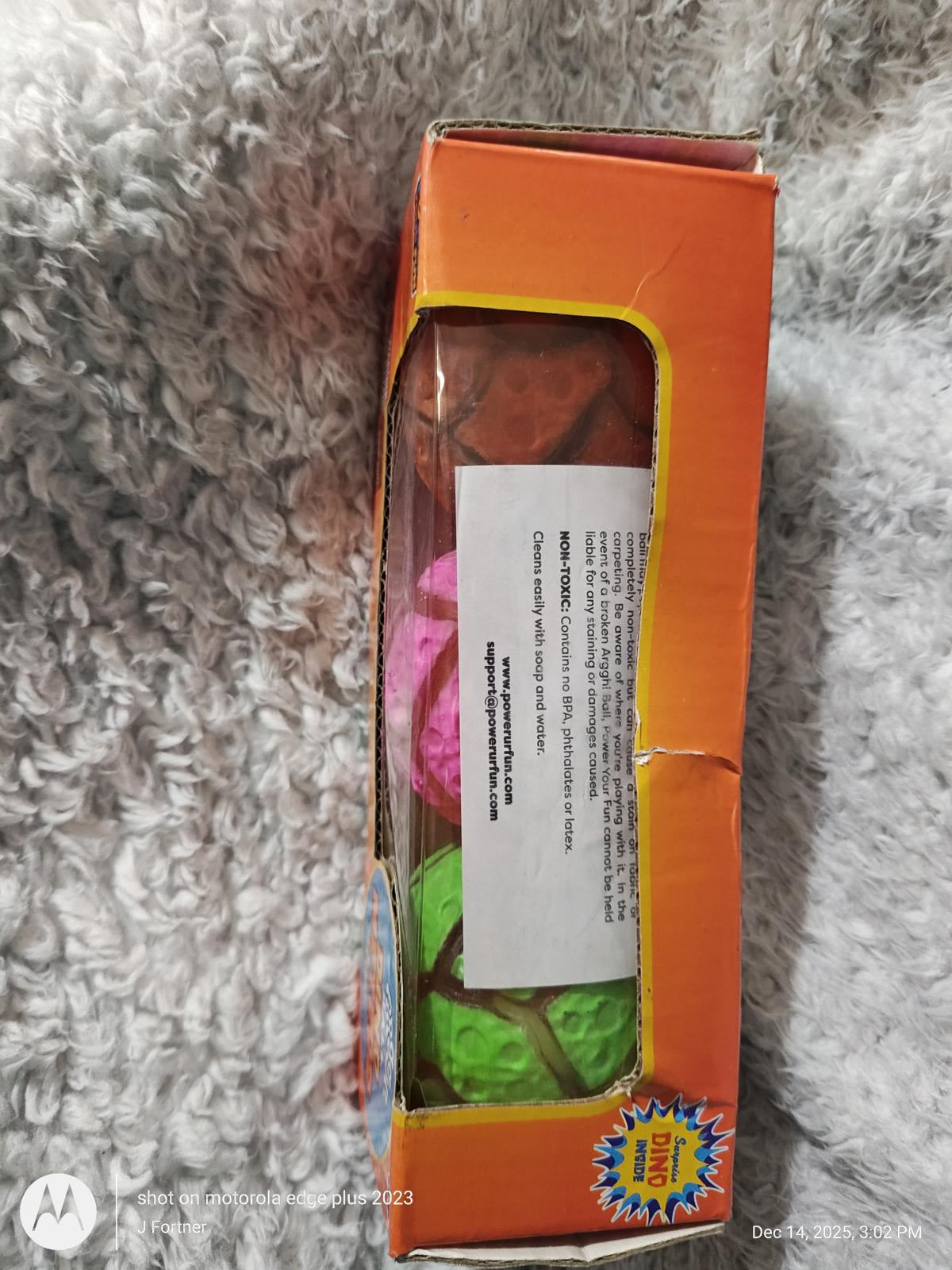 Colorful bouncy balls set featuring pink, green, and orange colors in a box.