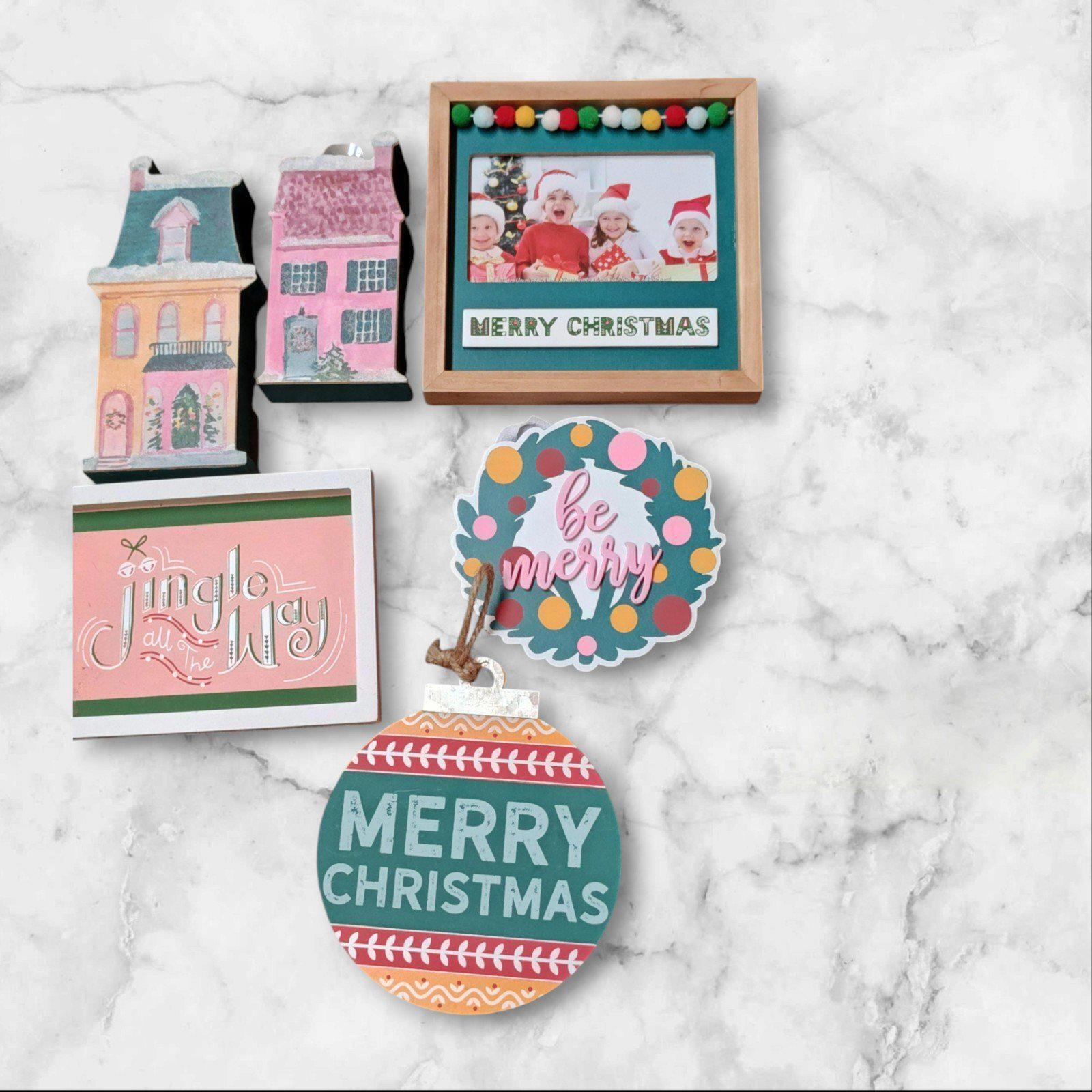 Merry Christmas decor set featuring colorful ornaments, festive cards, and a framed photo.
