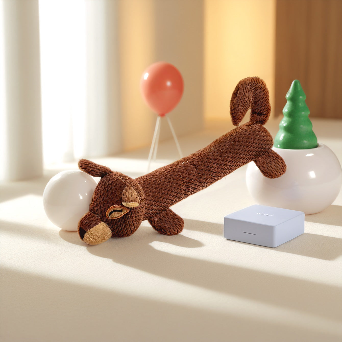 Brown plush dog toy with a long body and cute facial features, perfect for playtime.