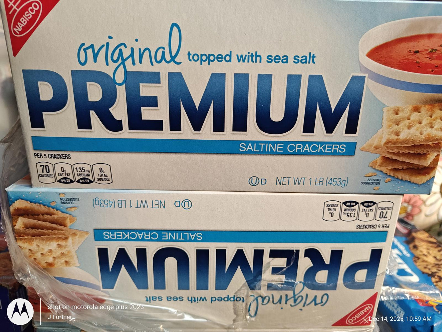 Premium saltine crackers topped with sea salt, packaged in a blue box.