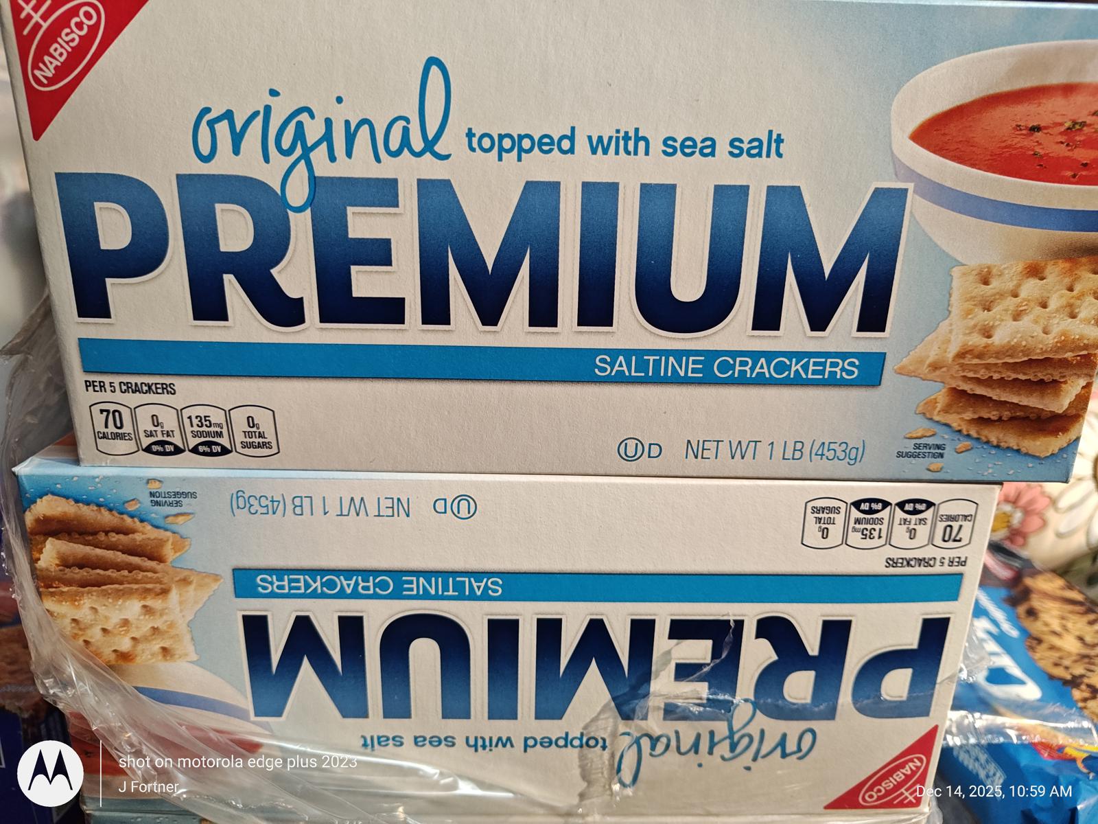 Premium saltine crackers topped with sea salt, packaged in a blue box.