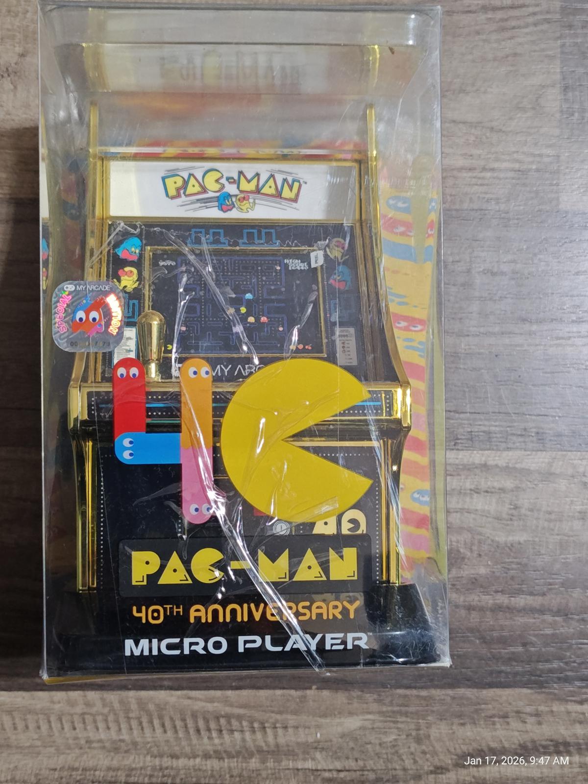 PAC-MAN 40th Anniversary Micro Player arcade game in a clear box with colorful graphics.
