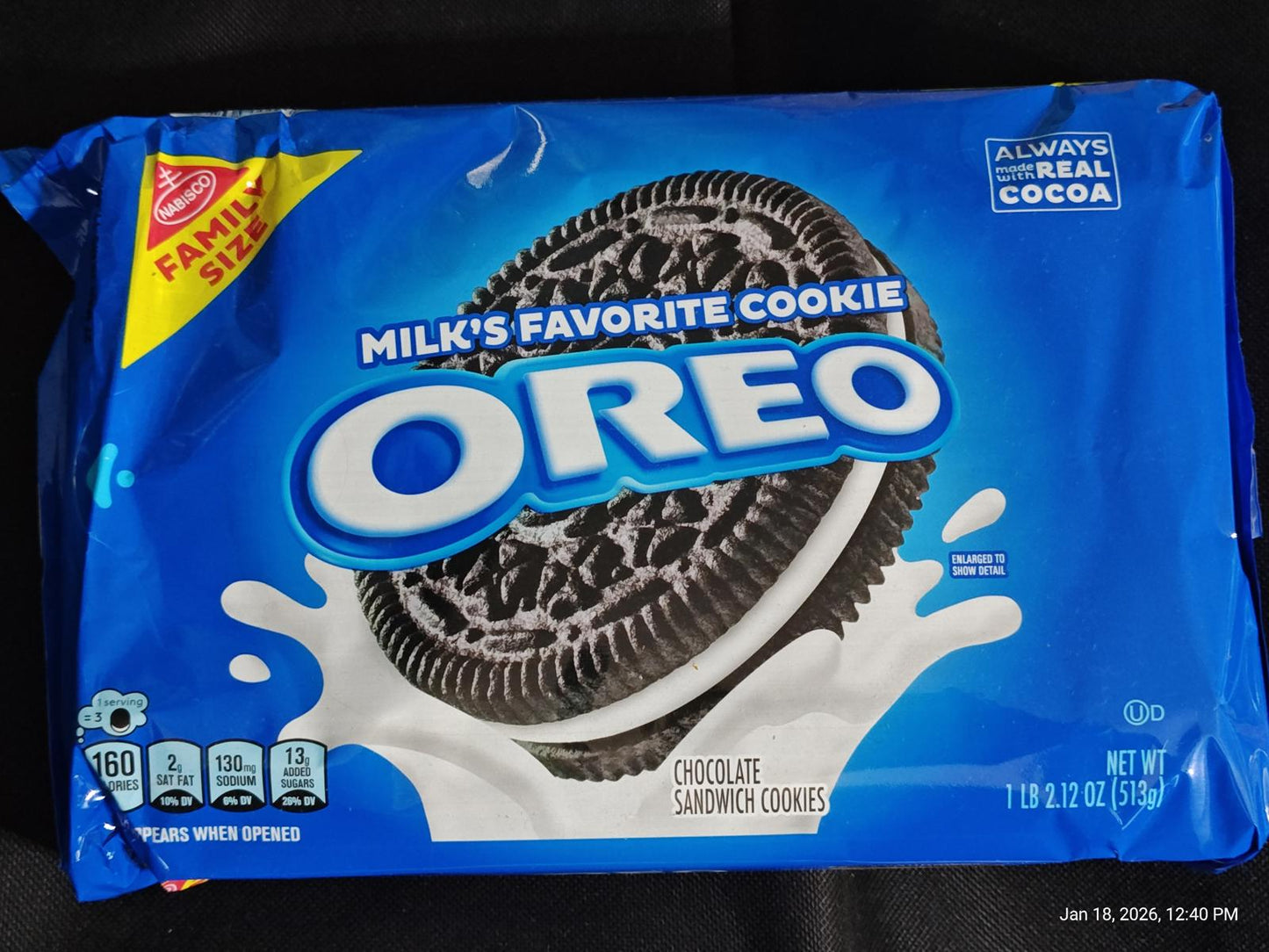 OREO cookies package featuring chocolate sandwich cookies with milk splash design.