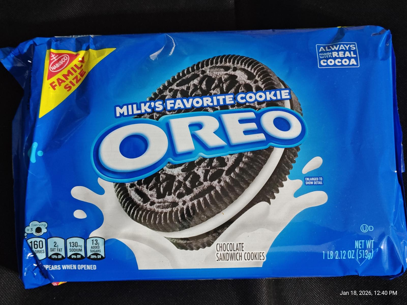 OREO cookies package featuring chocolate sandwich cookies with milk splash design.