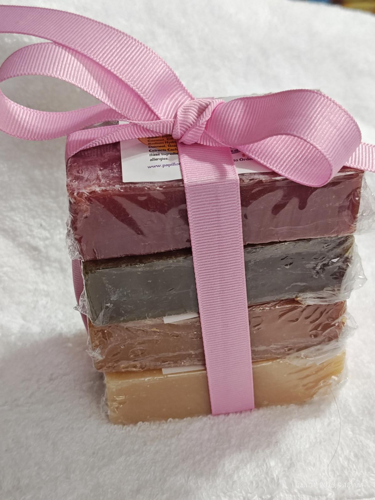Handmade soap gift set with five colorful bars wrapped in pink ribbon.