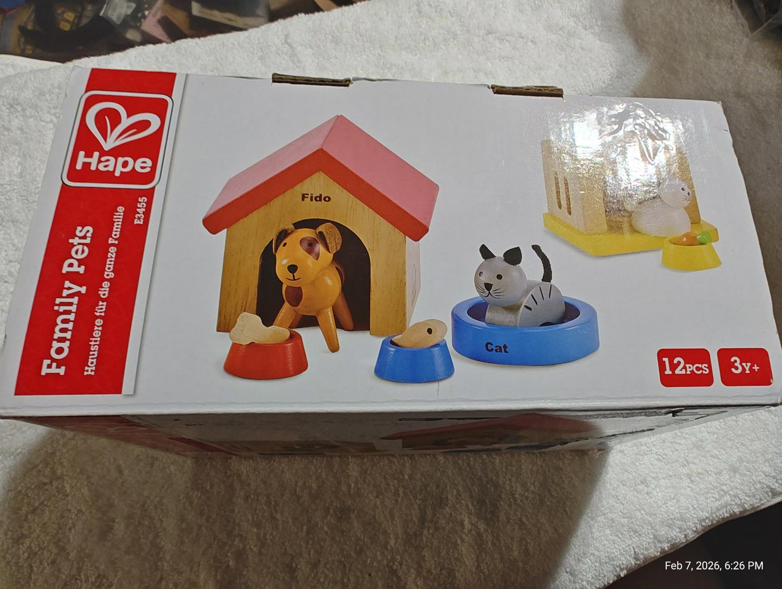 Hape Family Pets playset featuring a dog, cat, and pet accessories in vibrant colors.