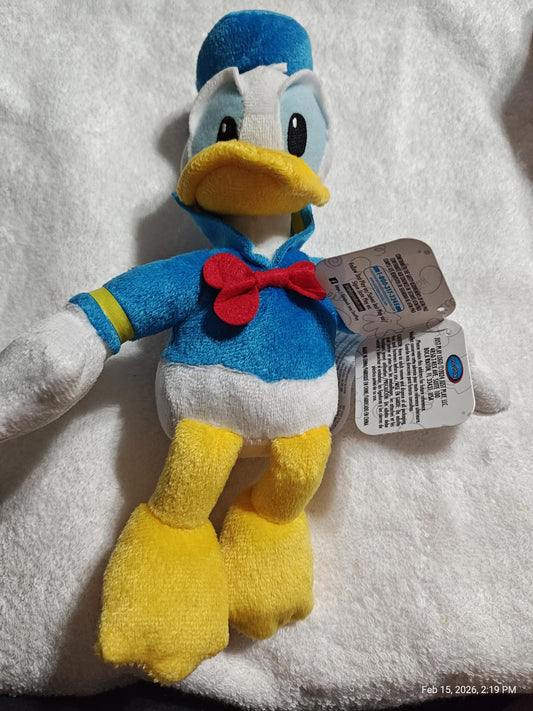 Donald Duck plush toy with blue outfit and yellow feet.