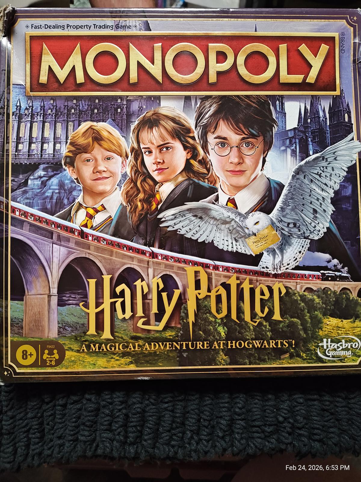 Monopoly Harry Potter board game featuring iconic characters and Hogwarts castle.