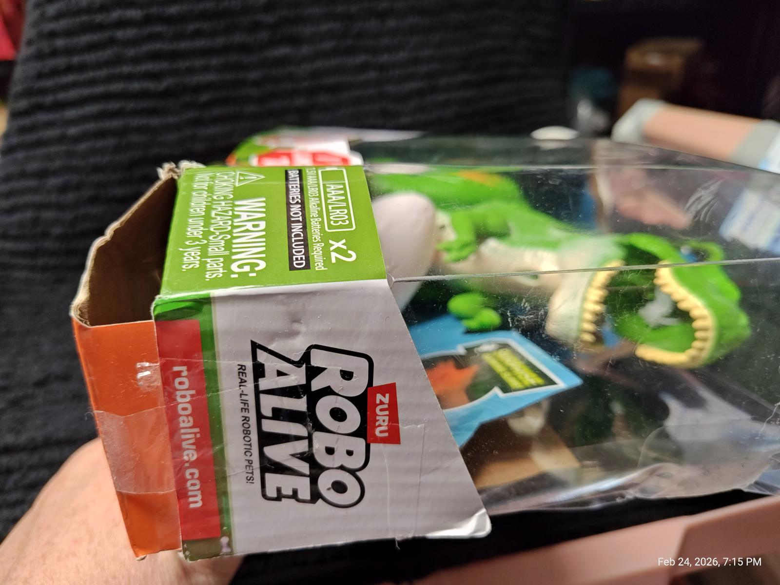 Robo Alive T-Rex toy in packaging, featuring vibrant green color and interactive features.