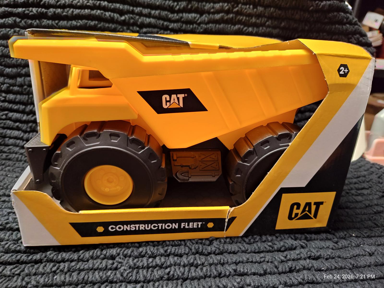CAT Construction Fleet toy truck in bright yellow with black wheels and branding.