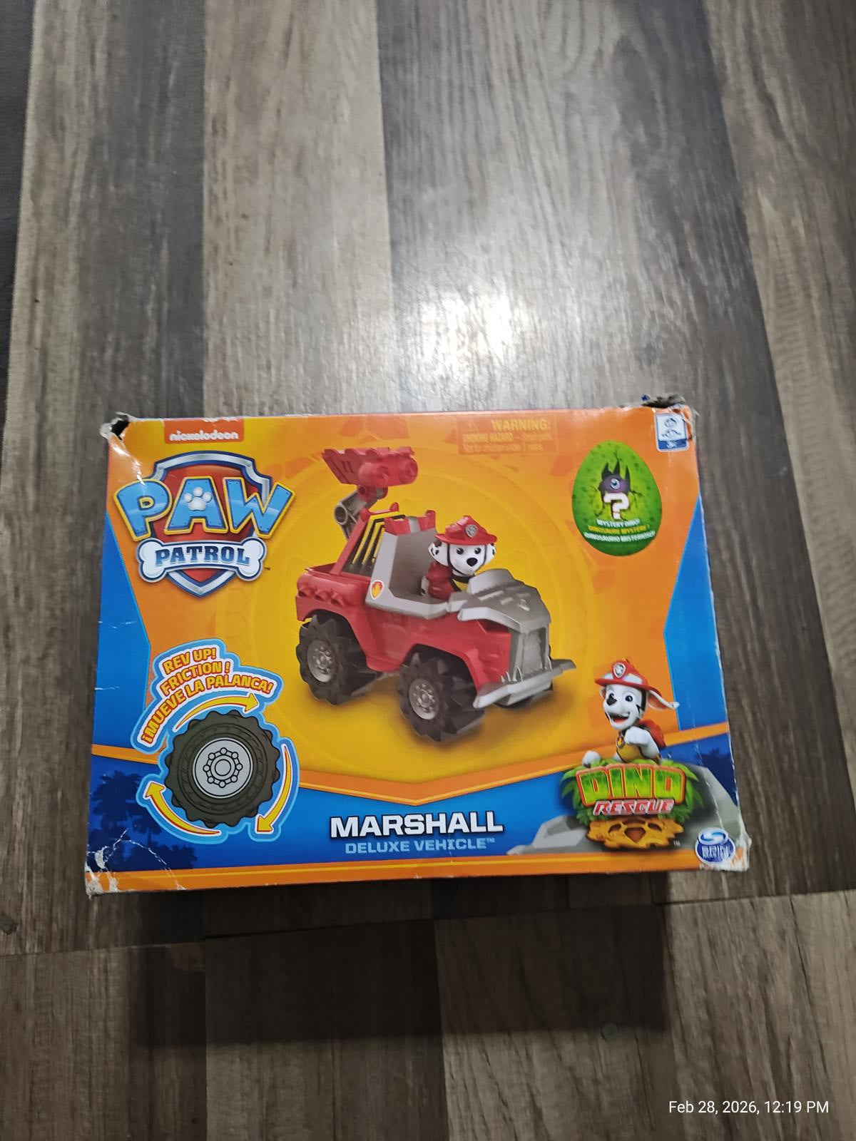 Paw Patrol Marshall deluxe vehicle featuring a red fire truck design with character figurine.