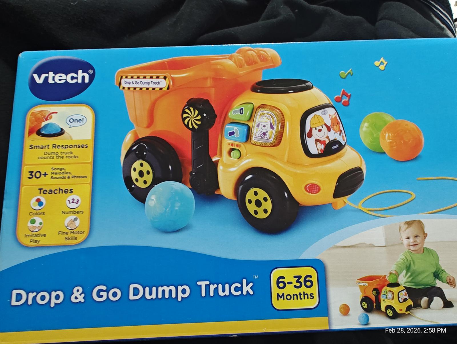 Drop and Go Dump Truck by VTech features colorful design and interactive elements for toddlers.