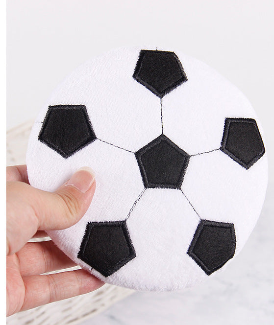 Soccer ball-shaped cleaning pad with black hexagonal patches for effective dusting.