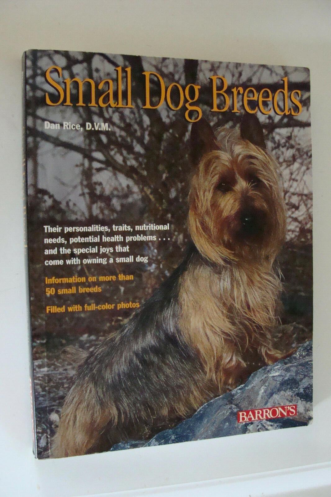 Small Dog Breeds book cover featuring a small dog with a scenic background.