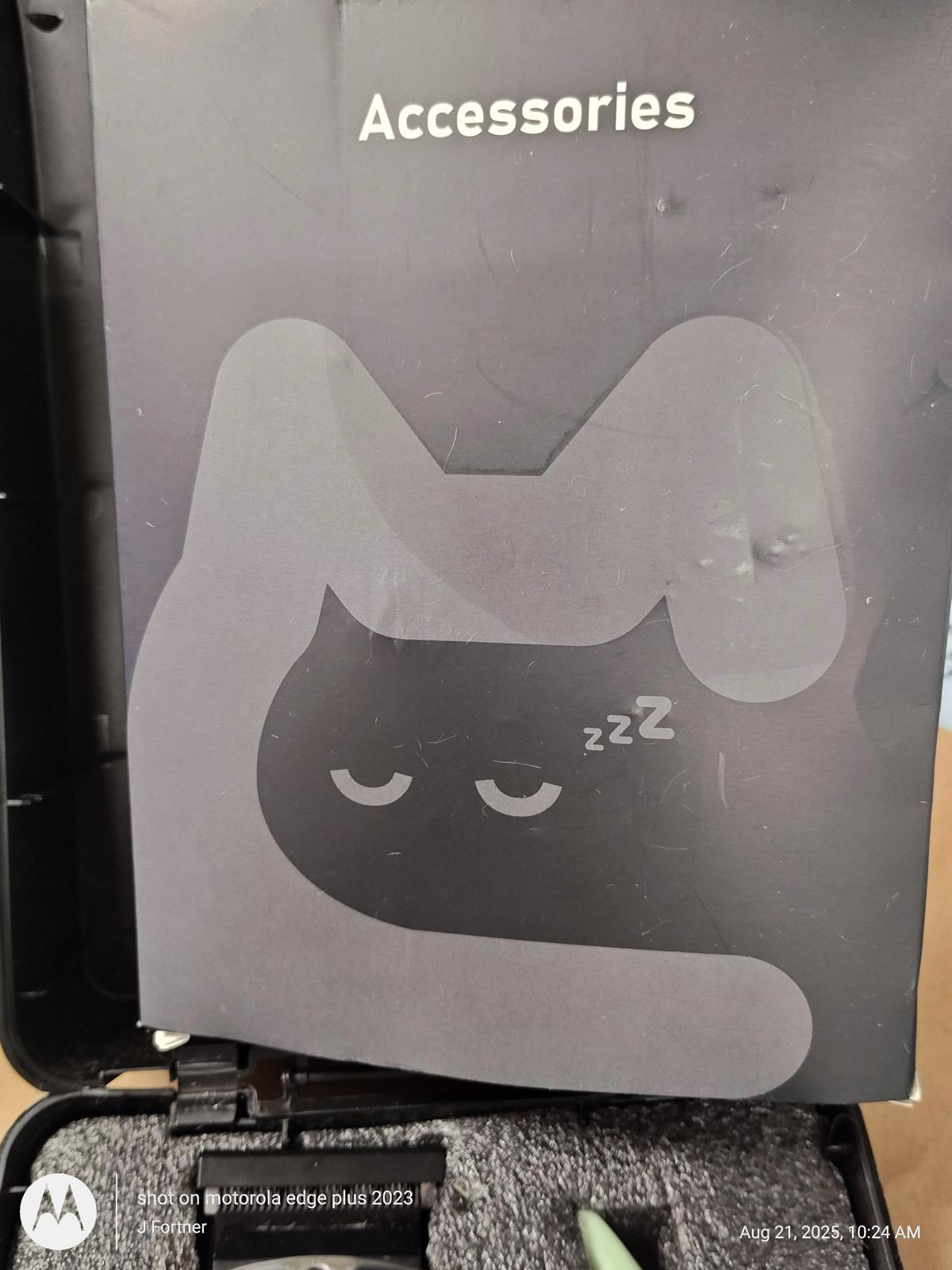 Accessories featuring a playful cat design with closed eyes and a sleeping expression.