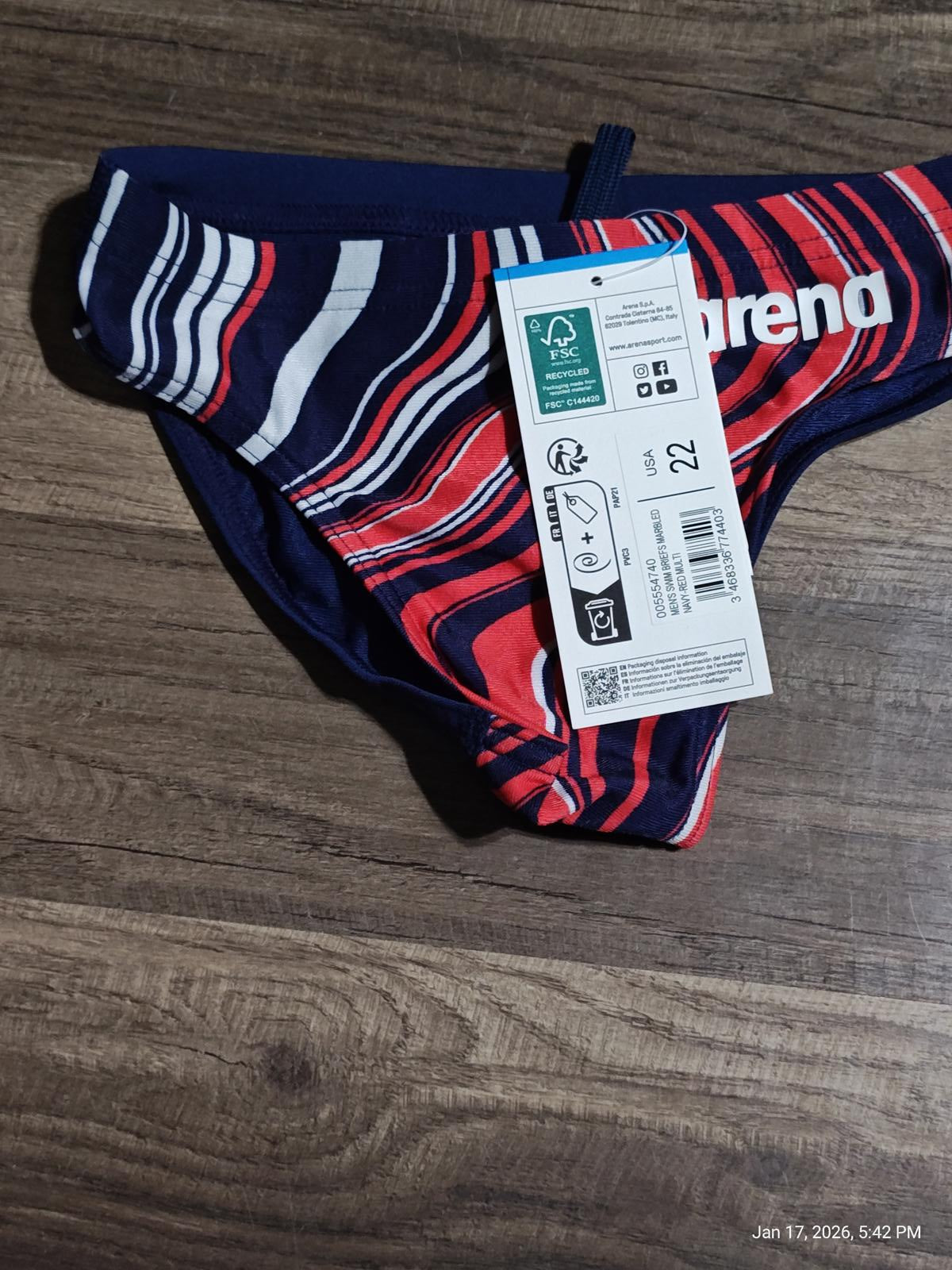 Arena swim briefs featuring a vibrant striped design in red and navy colors.