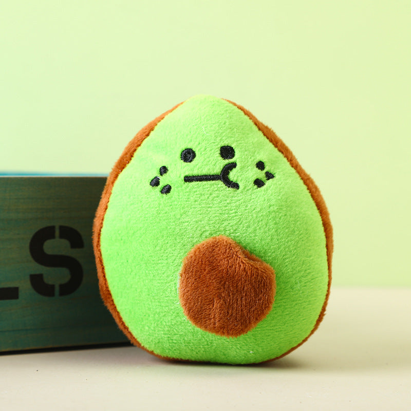 Avocado plush toy with a cute face and brown pit, perfect for cuddling.