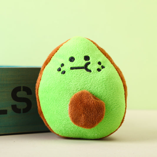 Avocado plush toy with a cute face and brown pit, perfect for cuddling.