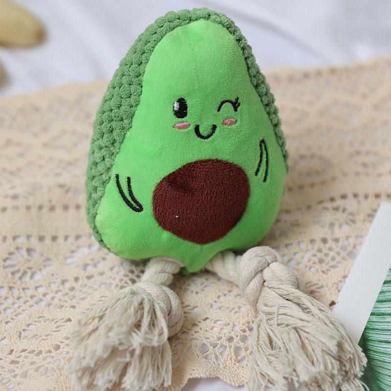 Avocado plush toy with a cute face and tassel legs, perfect for kids.