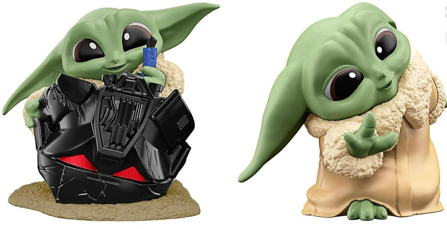 Baby Yoda figurine holding a blue object, featuring large ears and a soft robe.