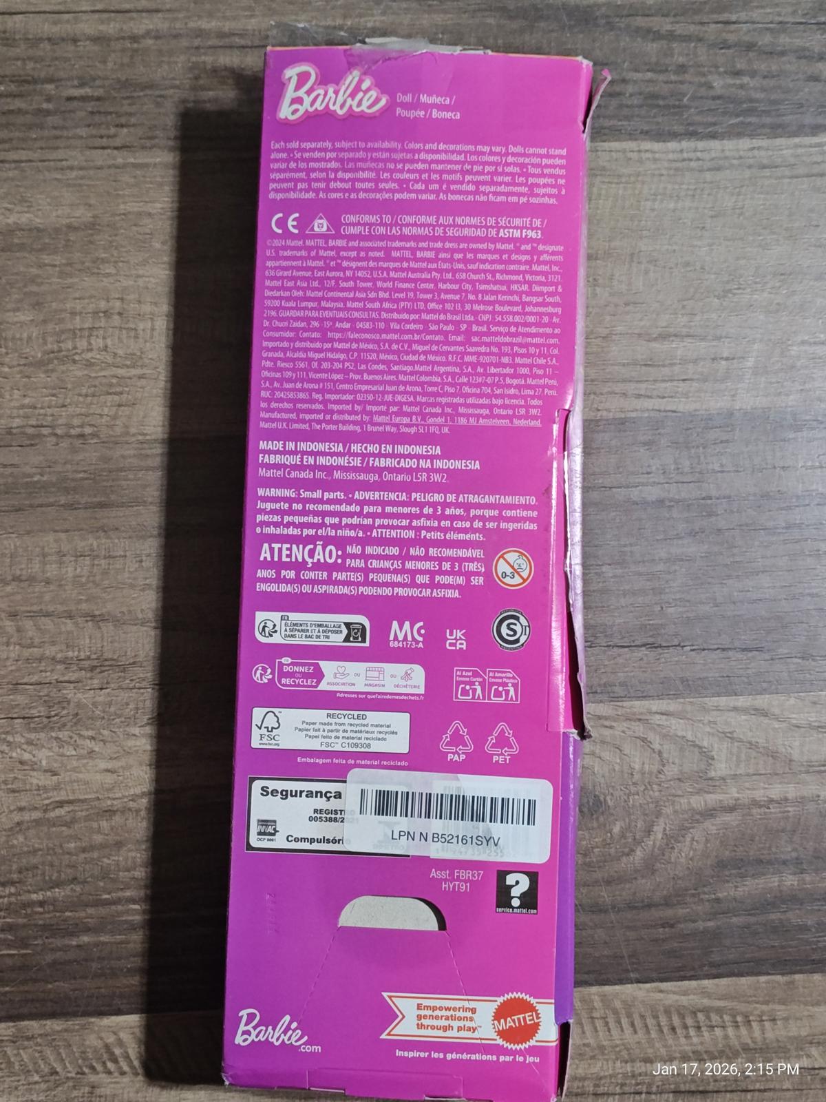 Barbie doll packaging featuring bright pink design and product details on the back.