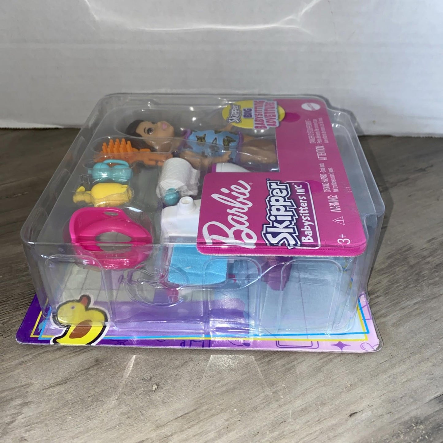 Barbie Skipper doll set with accessories including a hairbrush and colorful toys.