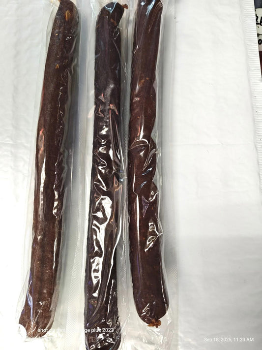 Beef Jerky Sticks in vacuum-sealed packaging, showcasing three long, dark brown sticks.