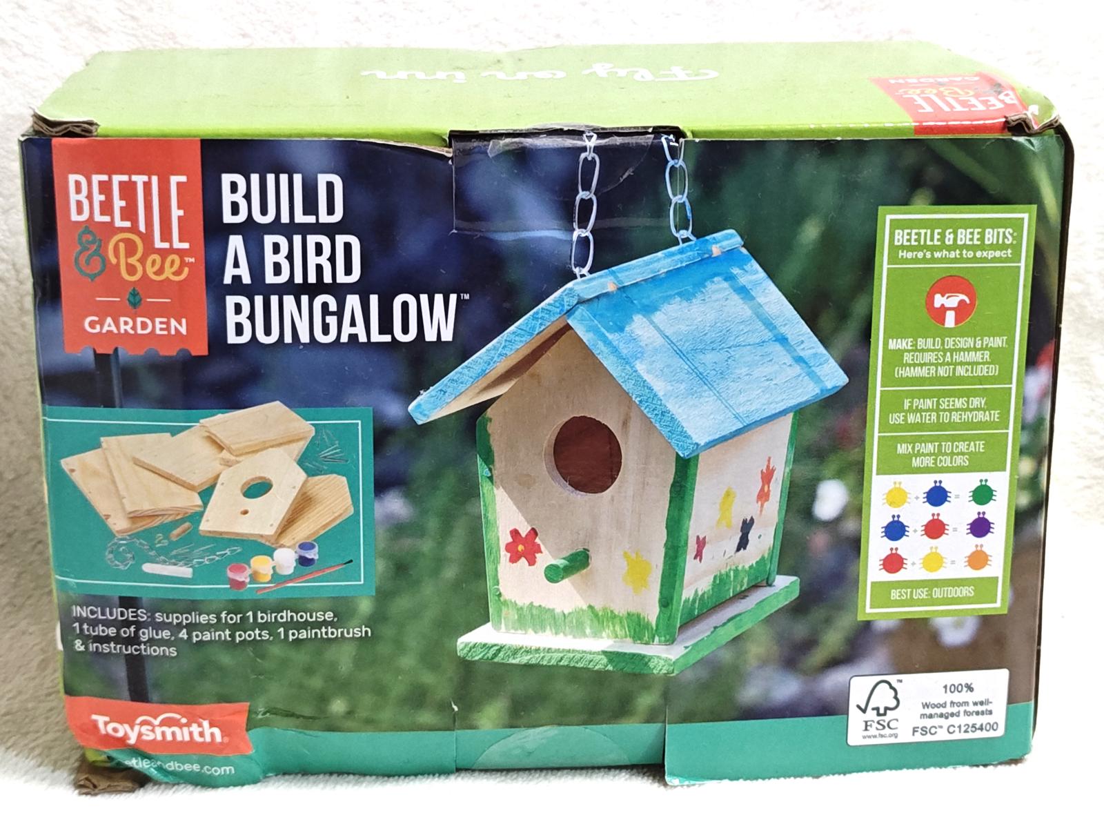Beetle & Bee Garden build a bird bungalow kit with colorful decorations and a blue roof.