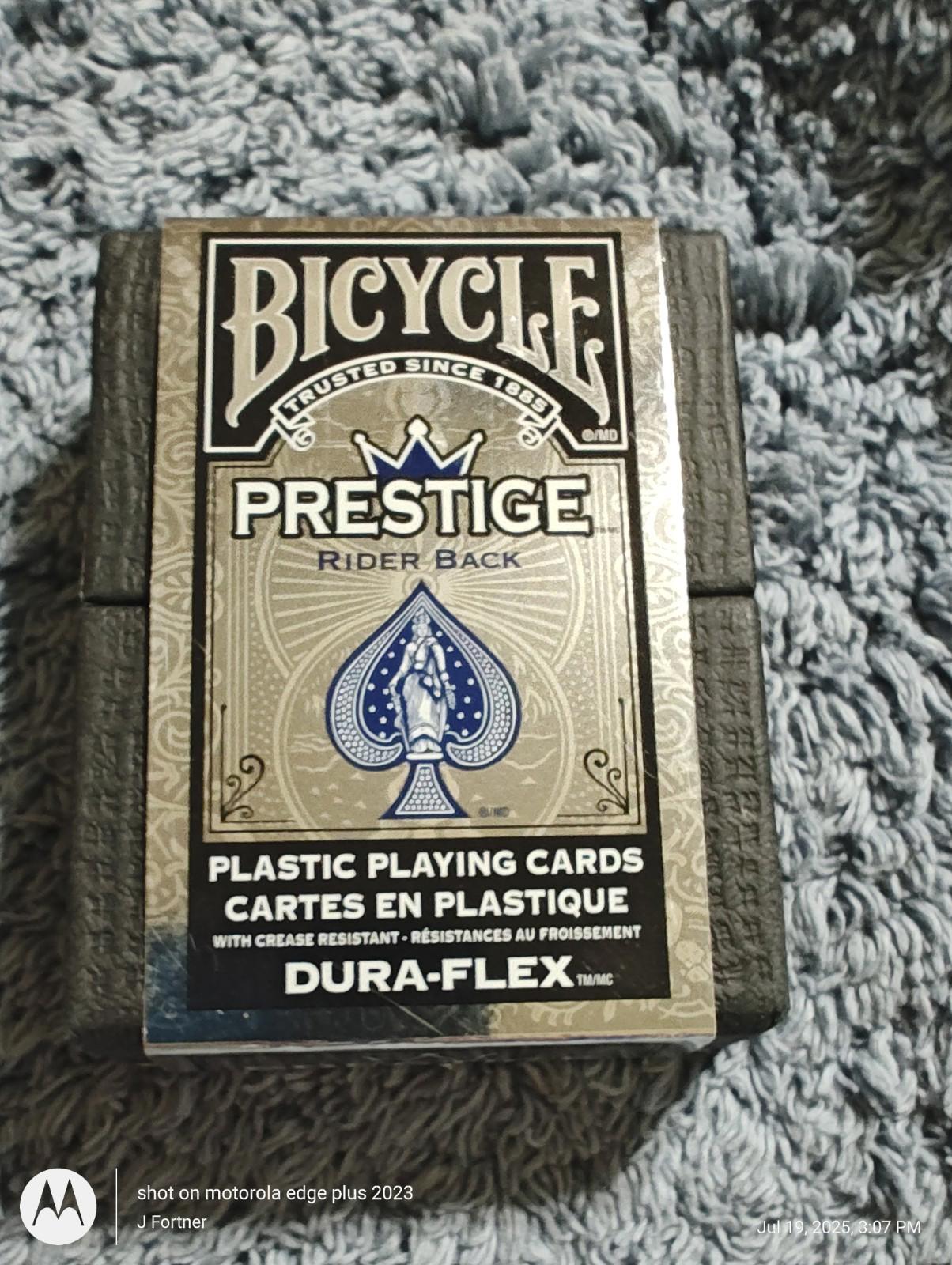 Bicycle Prestige playing cards featuring a blue spade design and durable Dura-Flex material.