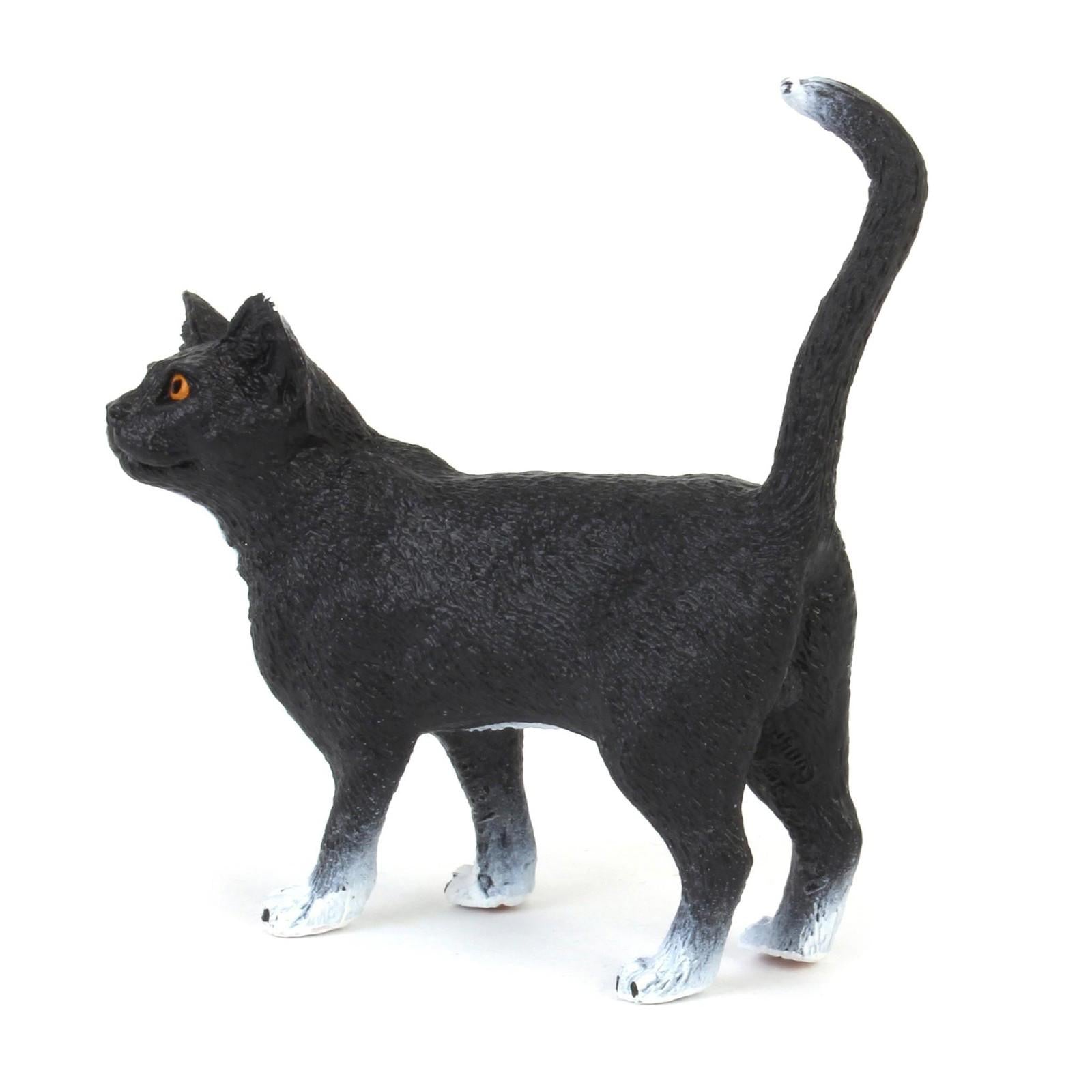 Black Cat Figurine with white paws and bright orange eyes.