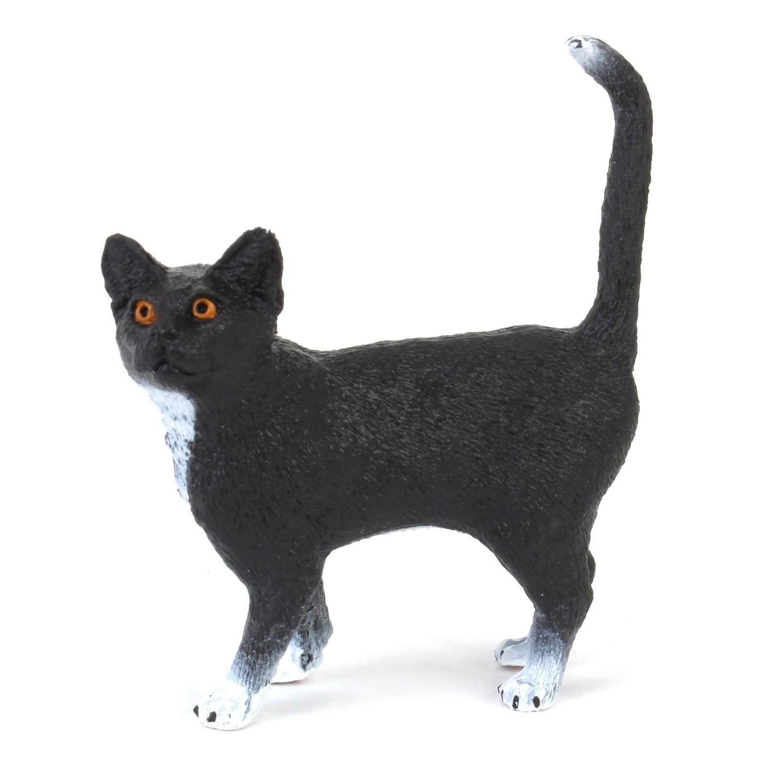 Black Cat Figurine with orange eyes and white paws.