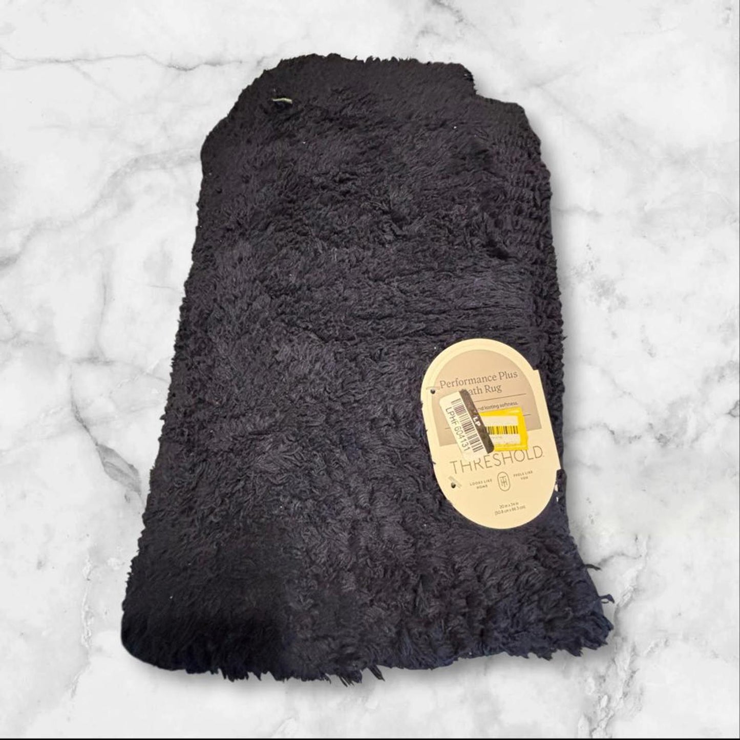 Soft black fleece throw blanket with tag, perfect for cozying up.