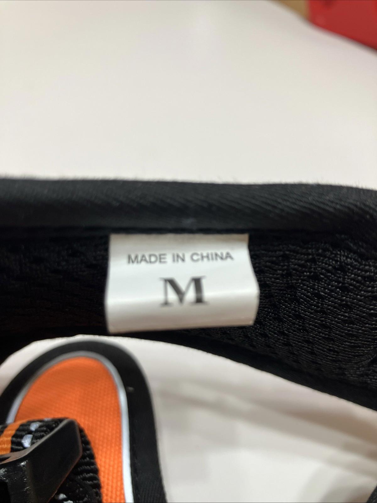 Product label showing size M and made in China on a black strap.