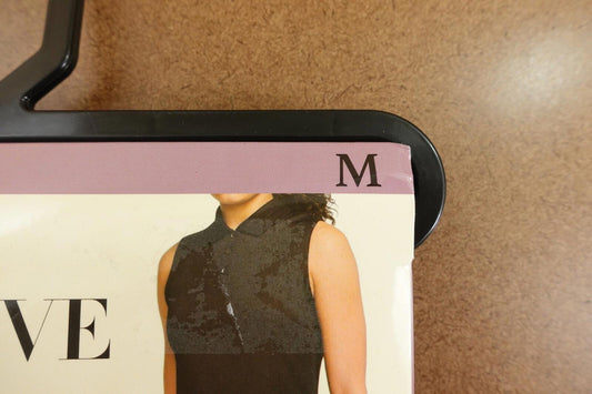 Black sleeveless top with a collar, size M tag visible.