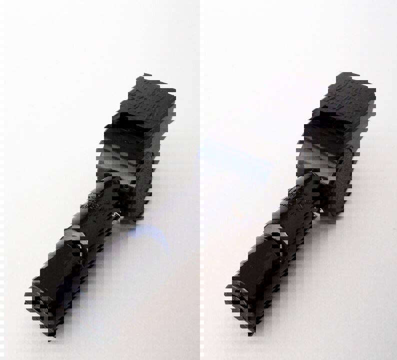 Black whistle with ergonomic design for easy grip and loud sound.