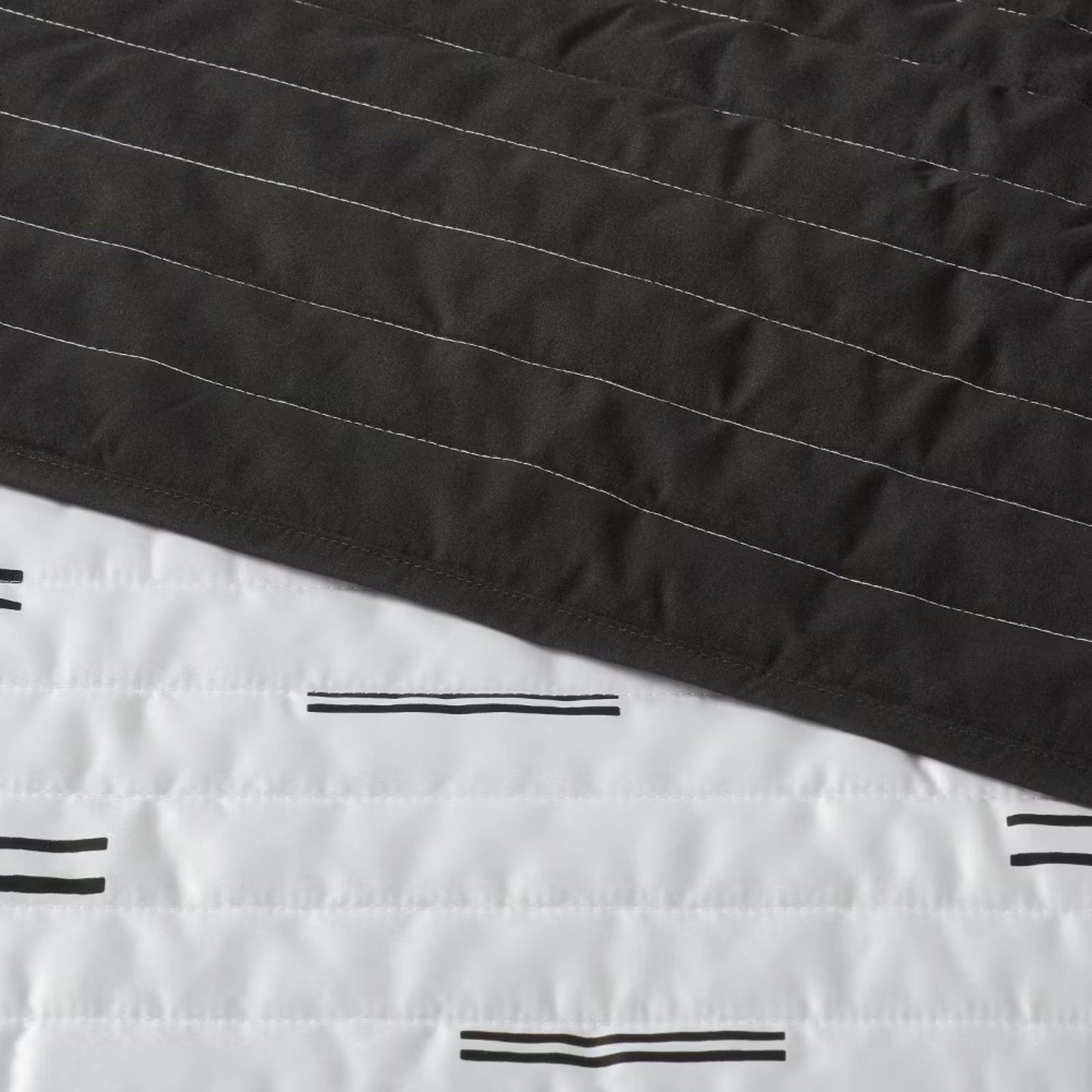 Black and white striped quilt featuring a modern design with contrasting colors.