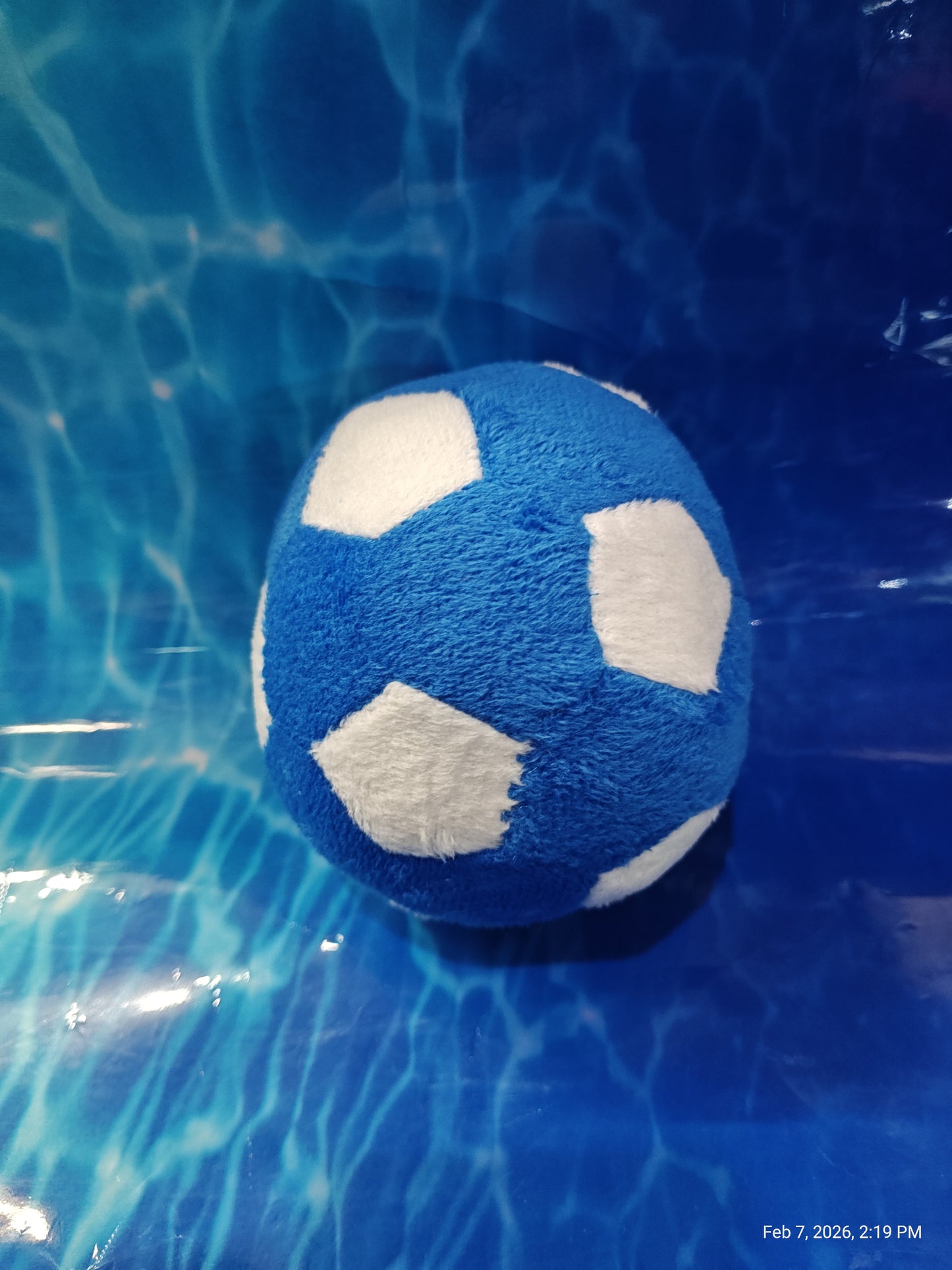 Blue Soccer Ball Plush Toy with white patches, perfect for kids' playtime.