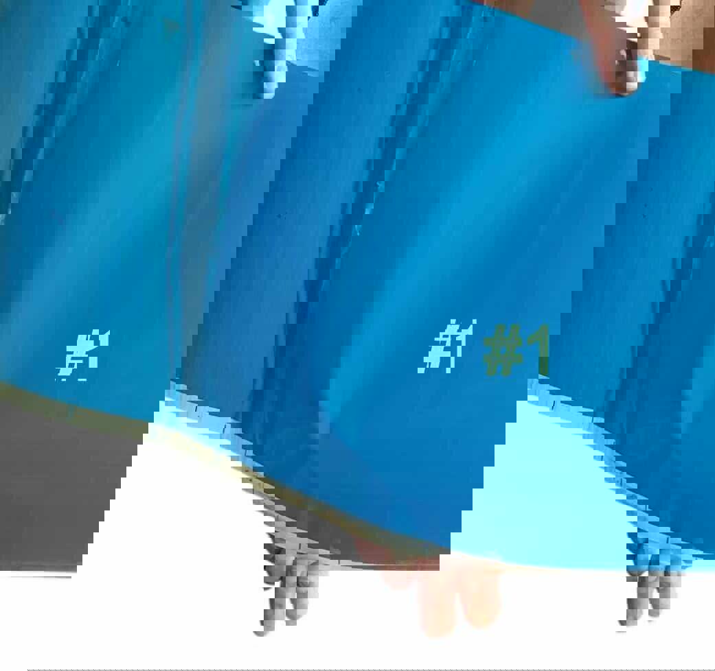 Blue training resistance band with number #1 printed, ideal for strength workouts.