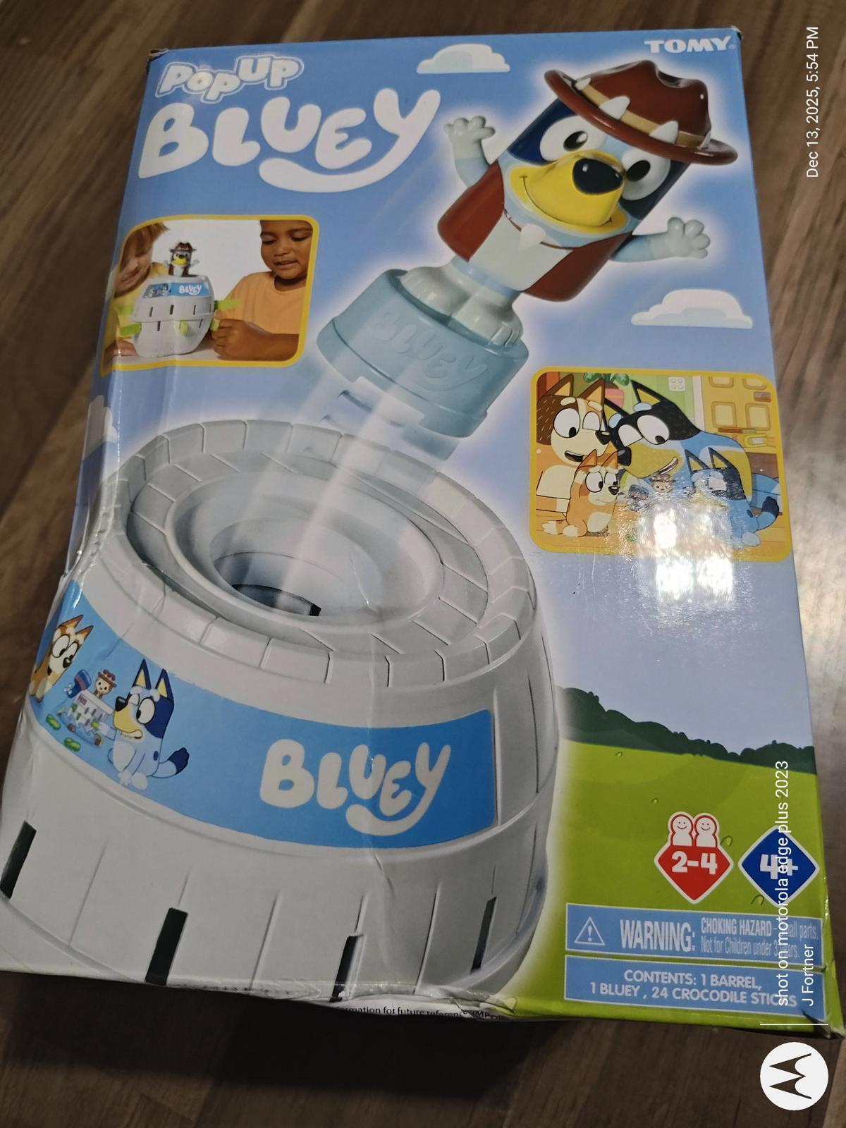 Pop Up Bluey toy featuring a playful design with Bluey character and colorful packaging.