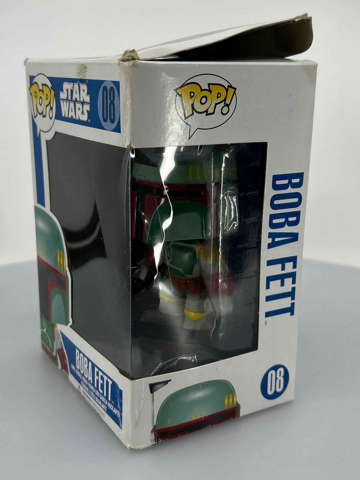 Boba Fett Funko Pop figure in box, featuring green and red colors with detailed design.