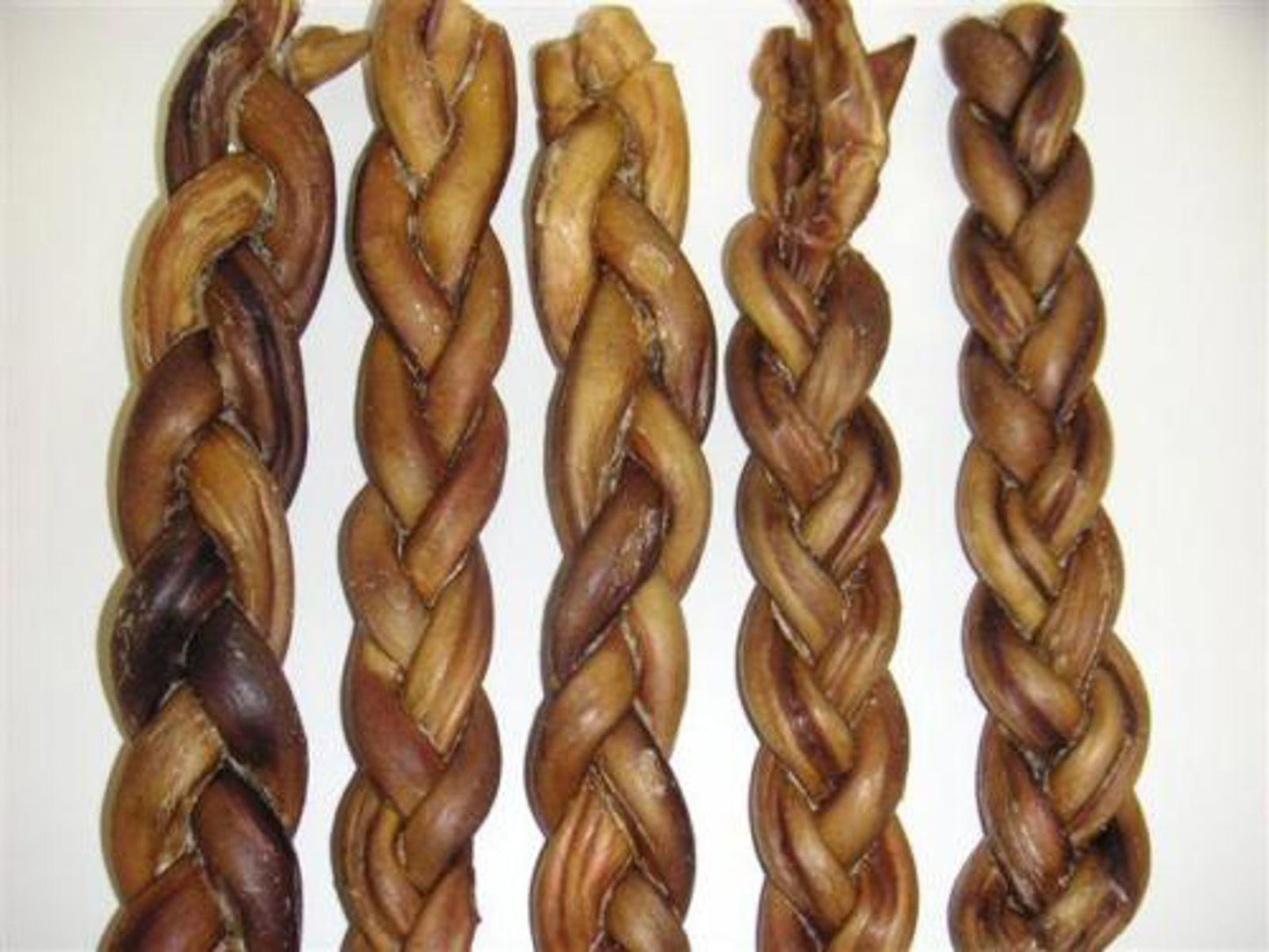 Braided dog chew sticks in various shades of brown, perfect for dental health.
